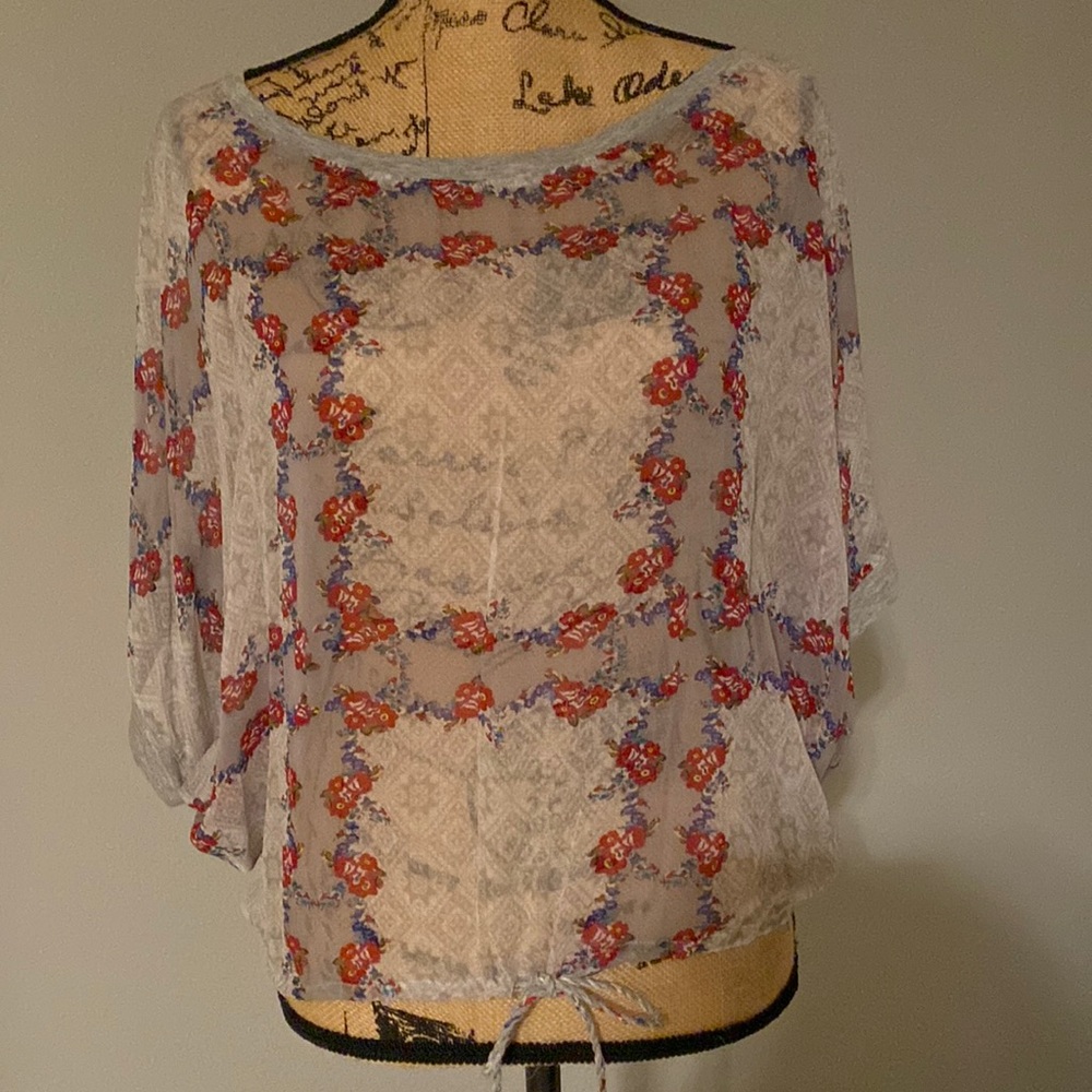 Language Sheer floral top. Lace on top of back.  Draw string tie bottom. Size S.